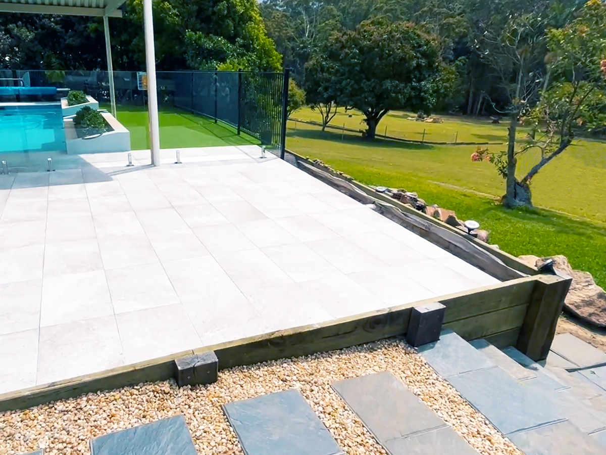 Retaining wall with paved pool area