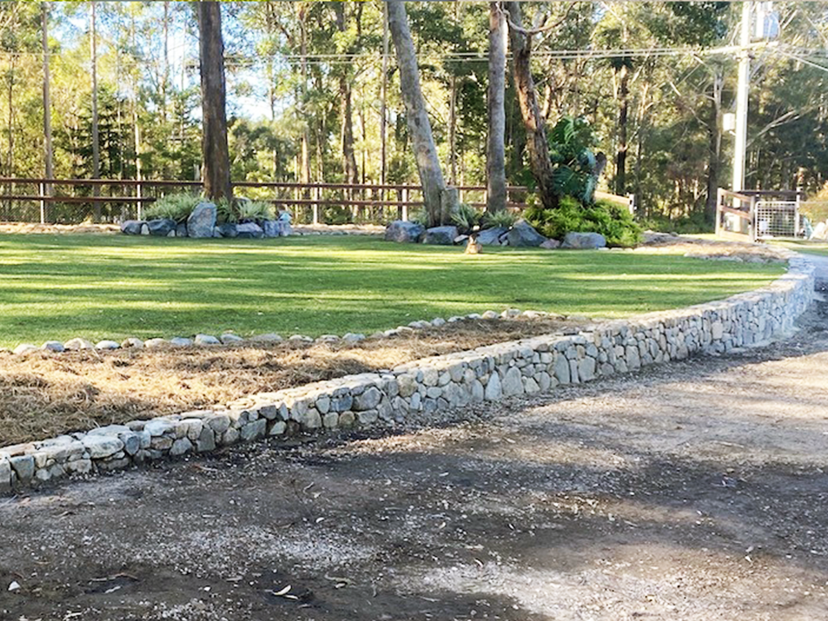 Long curved stone wall in Doonan