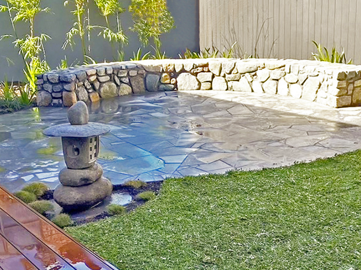 stone wall built seat in garden area